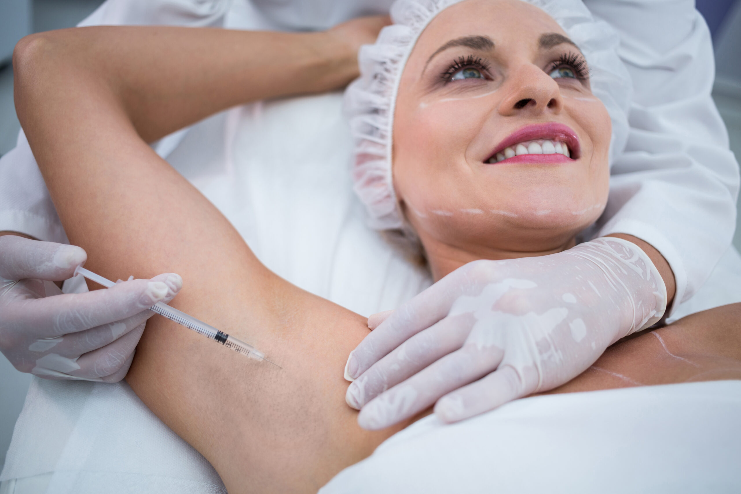 Woman during botox or botulinum toxin underarm procedure