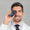 Dr. Sebastian Podlipnik holding a dermatoscope